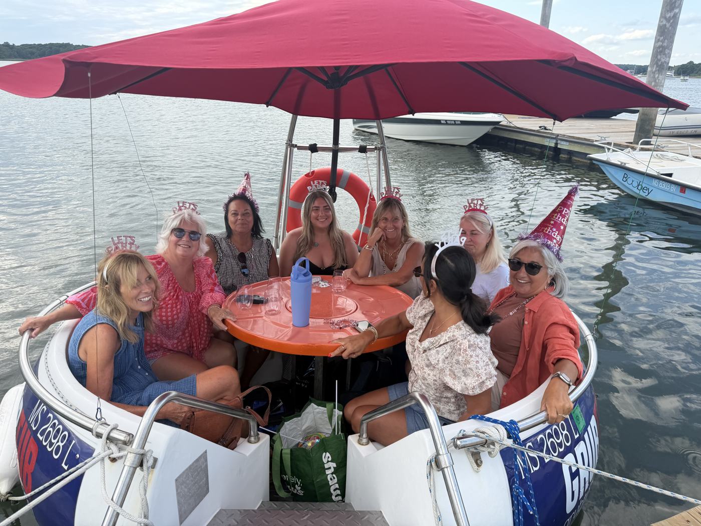 A birthday group in party hats on a GrubTub