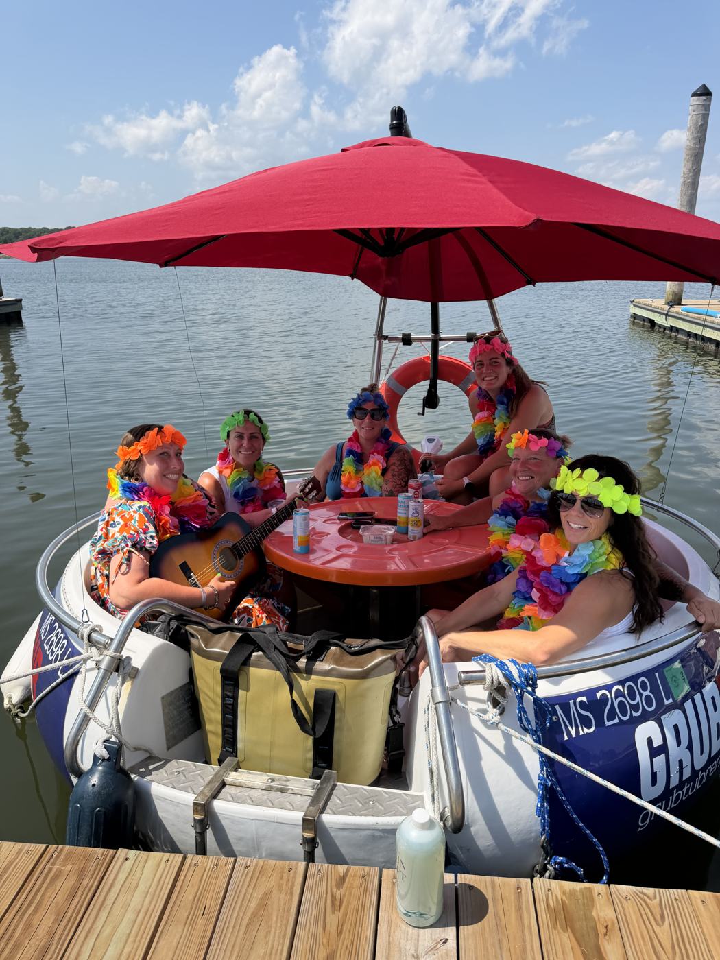 A bachelorette group in leis aboard a GrubTub